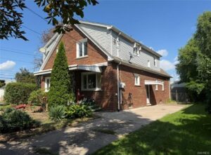 Exterior of the brick two-unit home at 563 27th Street in Niagara Falls